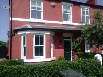 Mr R - Raby Mere, Wirral. Installation of Victorian sliding white PvcU Sash windows. double glazed A rated . . Front Door Bamborough Green GRP Composite door . Bespoke Headlight to clients design. 